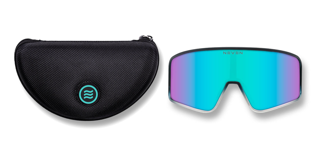 View of large black hard-shell textured zippered sunglasses case with teal round Neven tilde logo and G.O.A.T shield lens sunglasses 