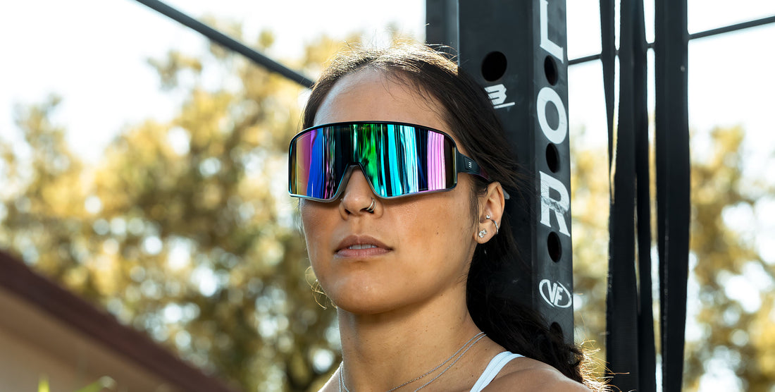 Woman wearing G.O.A.T. polarized sunglasses outdoors with mirrored blue and purple lenses