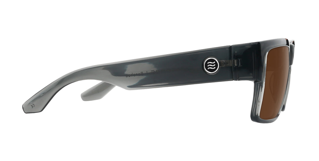 Right-side close-up of Banshee prescription sunglasses showcasing transparent gray temple, circular logo, and brown lens on white background