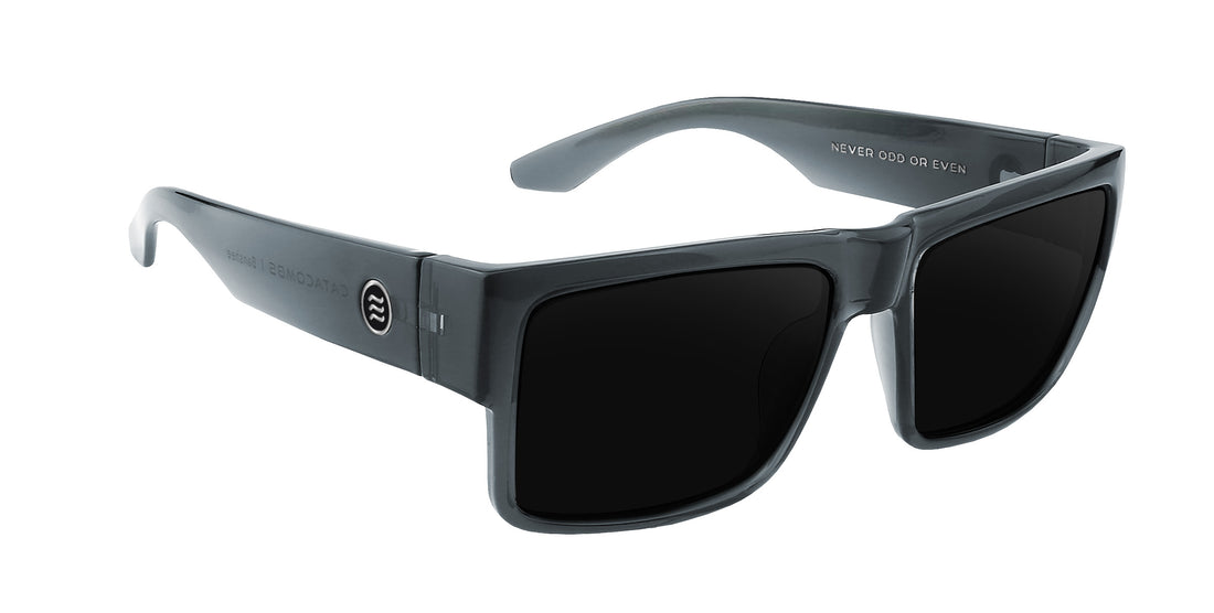 Three-quarter view of Banshee sunglasses showcasing glossy transparent gray rectangular frame and dark prescription lenses on white background