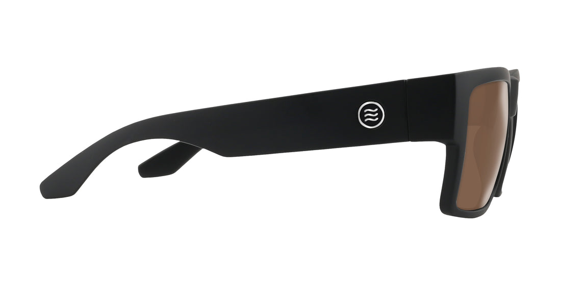 Side view of Relic prescription sunglasses in matte black with wide temple, circular logo, and brown lenses on white