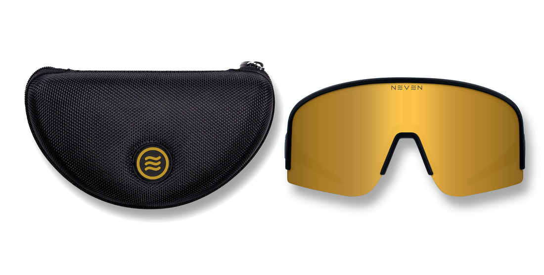 Front view of PR polarized shield sunglasses with black frames and gold mirror lens beside a black textured case