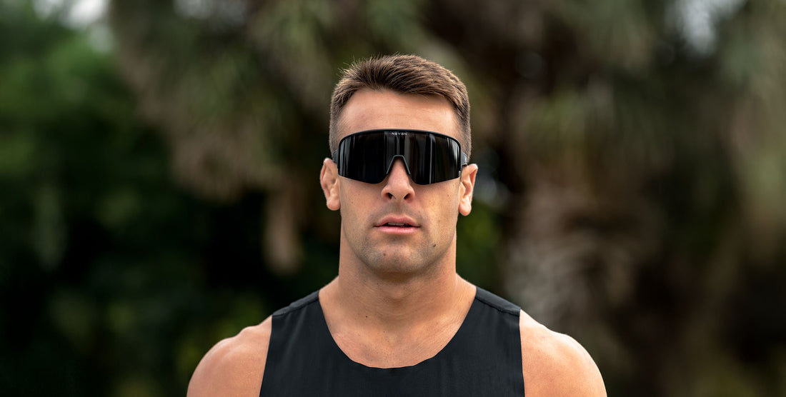 Man wearing black Threshold wraparound polarized sunglasses outdoors with blurred greenery