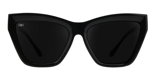 Nocturnal black cat-eye sunglasses with dark lenses.