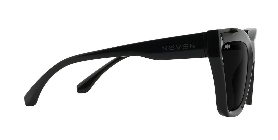 Side view of Nocturnal cat-eye sunglasses showing glossy black frame, Neven temple logo and moon-phase etch on white