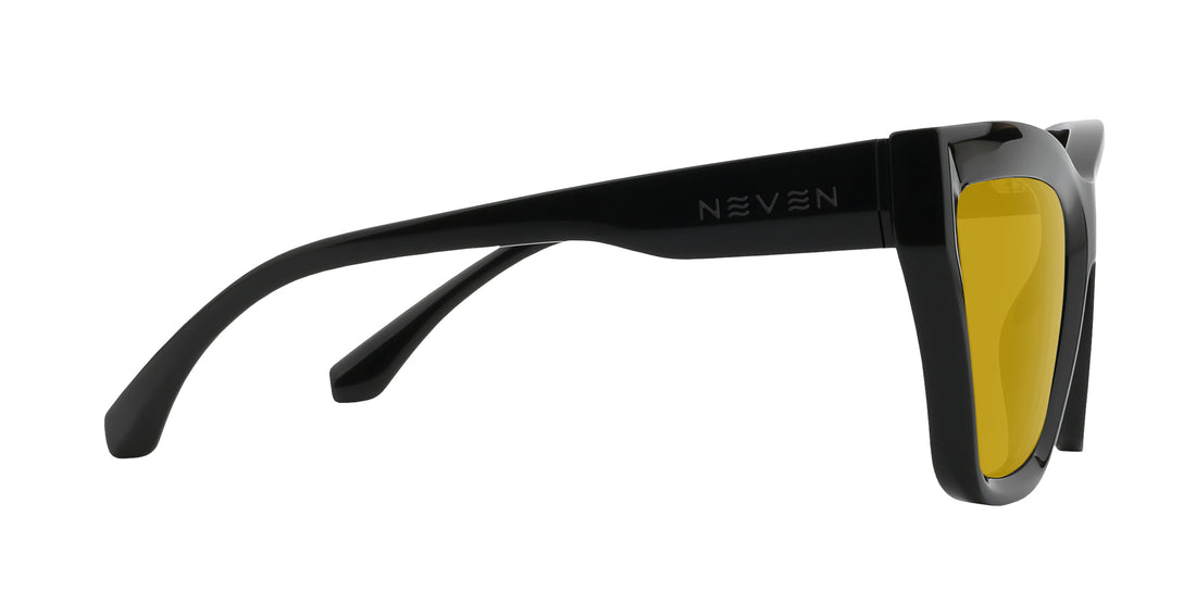 Side view of Nocturnal cat-eye sunglasses showcasing glossy black frame, yellow lenses and Neven logo on white background