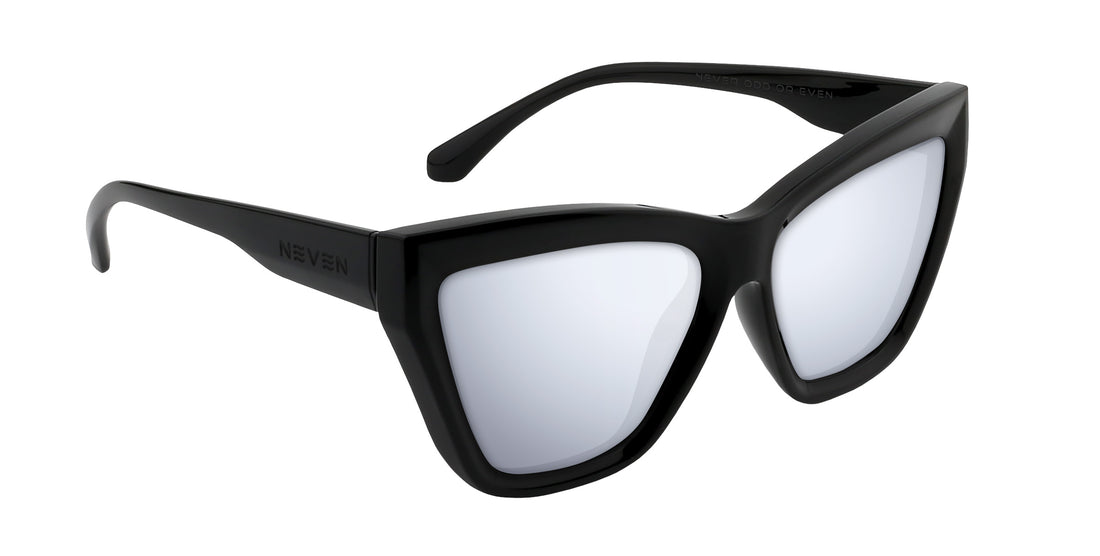 Angled close-up of Nocturnal cat-eye sunglasses with glossy black frame and silver mirrored Rx lenses on white background