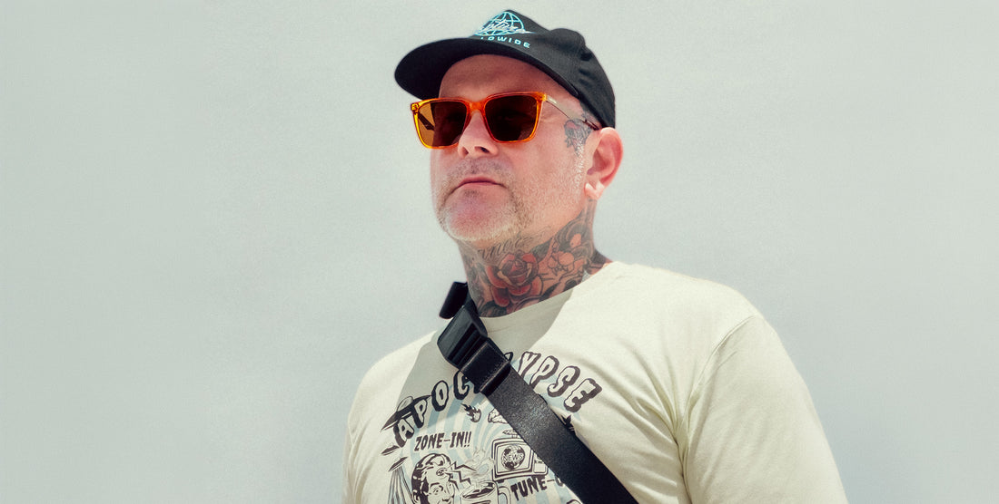 Man wearing Java orange amber transparent sunglasses with brown polarized lenses against a gray background