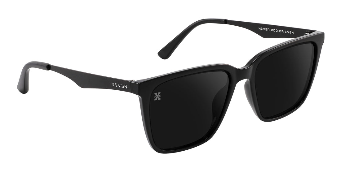 Angled close-up of Mamba sunglasses showing glossy black frame, polarized black lenses, and matte metal temples on white background