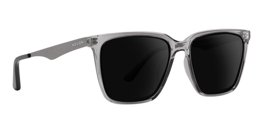 Front three quarter view of Tornado prescription sunglasses showcasing transparent gray frames and silver metallic temples with black lenses on white background