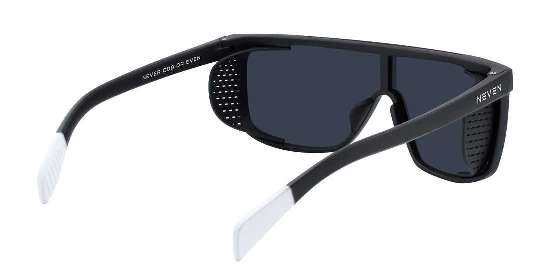 Rear-angled Pitch Black sunglasses with removable side shields, matte black frame, white tips, polarized lenses