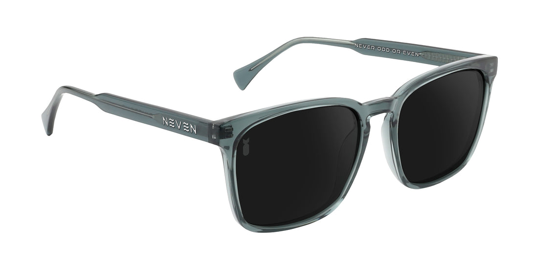 Three-quarter view of Lenny sunglasses with transparent gray rectangular frame, polarized black lenses, and Divebomb logo