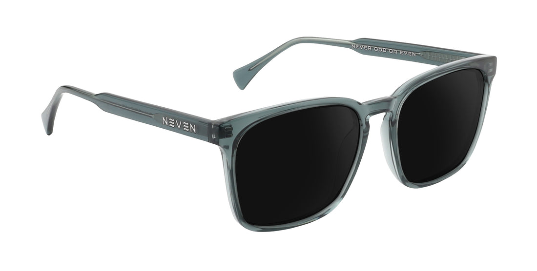 Three-quarter view of Lenny prescription sunglasses showcasing a transparent glossy gray rectangular frame and dark lenses on white