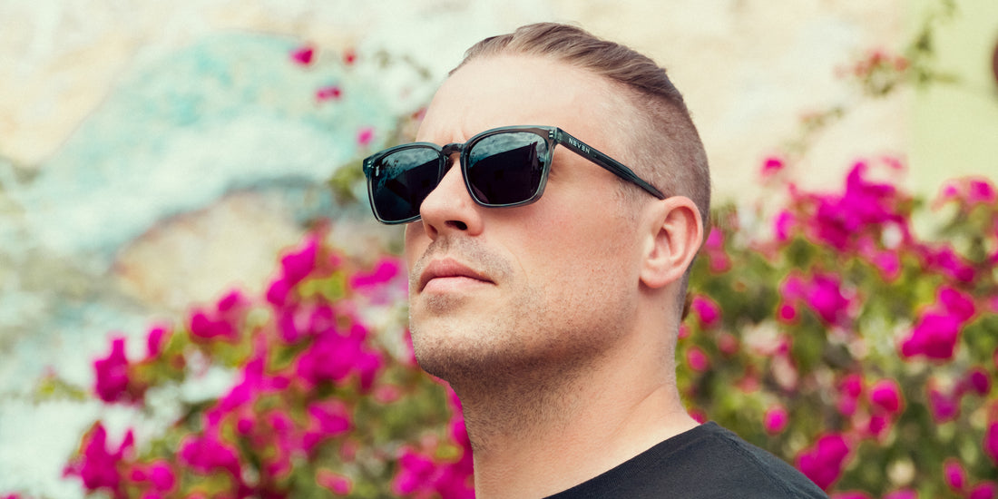 Man wearing Lenny polarized sunglasses outdoors with colorful flowers in the background