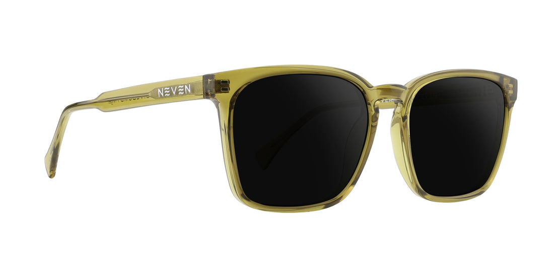 Right three-quarter close-up of Nigel prescription sunglasses with transparent olive green frame, dark lenses, NEVEN logo