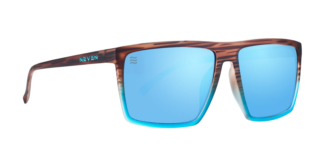 Front view of Melby XL sunglasses showcasing a gradient wood-to-turquoise frame and light blue mirrored lenses on a white background