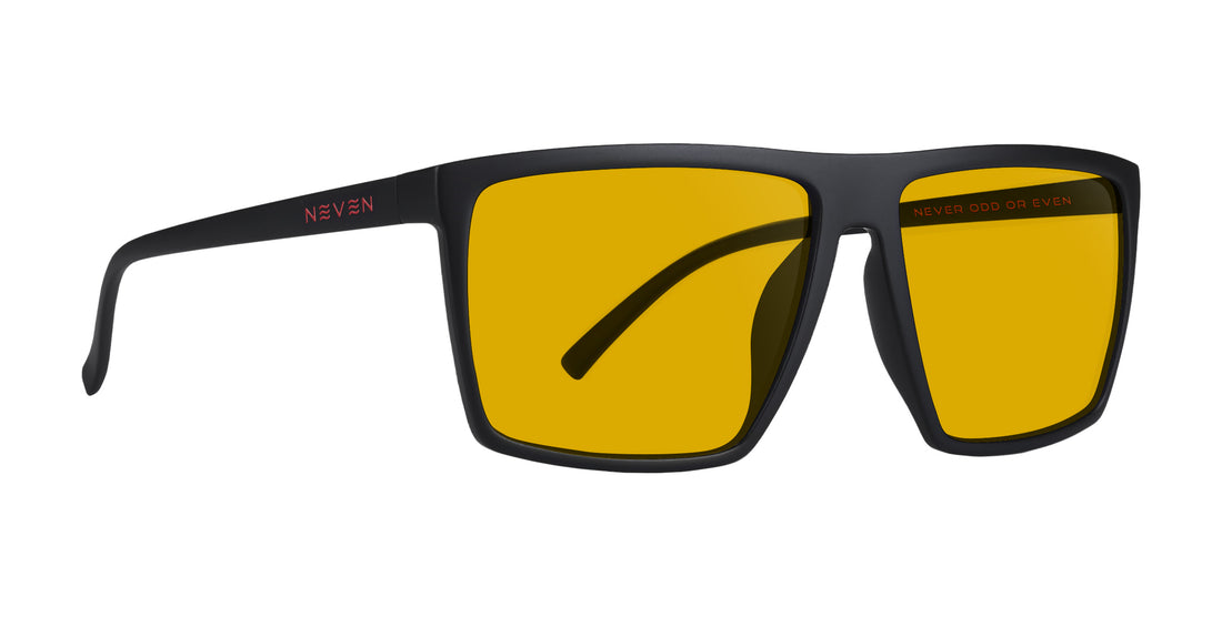 Front-right close-up of 212 prescription sunglasses showing matte black square frame, yellow prescription lenses, and NEVEN logo on temple on white background