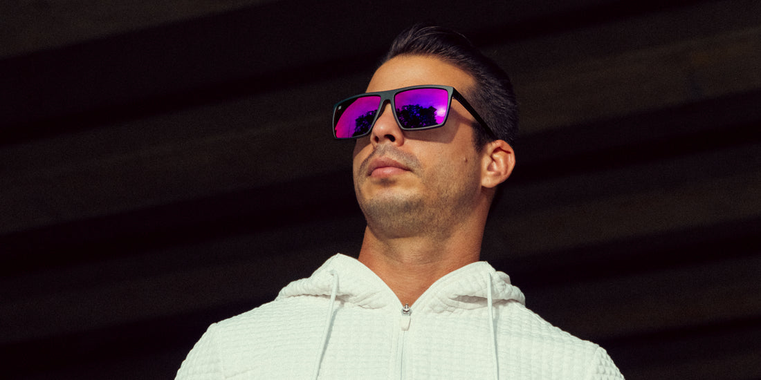 Man wearing 88th Street black sunglasses with polarized purple mirrored lenses against a dark background