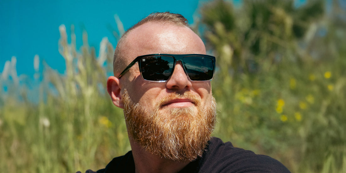 Man wearing Colorado Bulldog XL sunglasses outdoors, glossy black-to-clear rectangular frame with dark polarized lenses