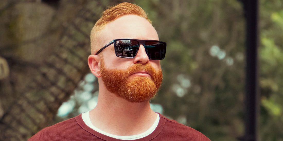 Man wearing NYC XL black rectangular polarized sunglasses outdoors, close-up showing large frame and dark lenses