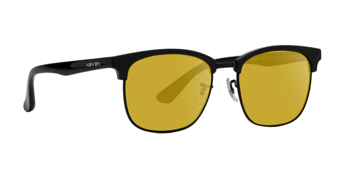 Close-up of Stealth prescription sunglasses showing black TR90 half-rim frame with yellow lenses on white background