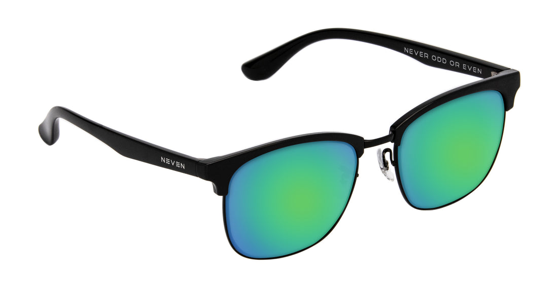 Angled close-up of Stealth prescription sunglasses showcasing black TR90 aviator frame and green mirrored lenses on white background