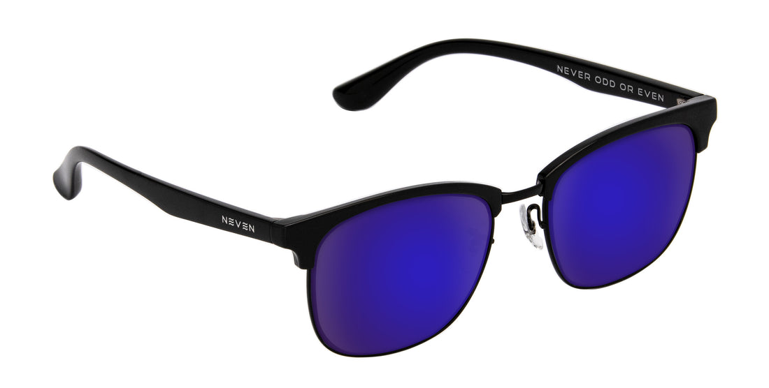 Angled close-up of Stealth prescription sunglasses with black TR90 aviator frame and purple mirrored lenses on white