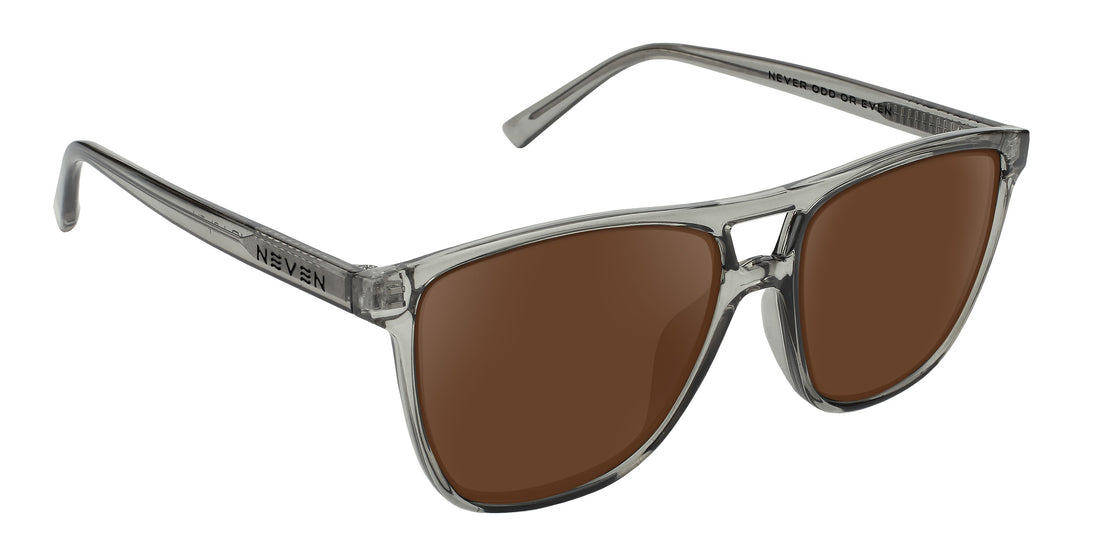 Angled close-up of Rip Tide sunglasses showcasing translucent gray square frame and brown prescription lenses on white background