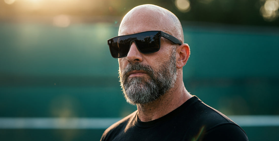 Man wearing Bold XL black oversized polarized sunglasses outdoors at sunset