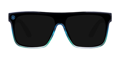 Close-up front of Turnstile XL sunglasses with blue-green gradient frame and polarized black shield lens