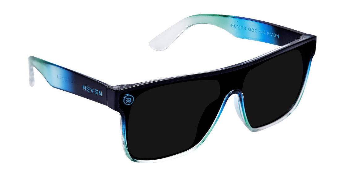 Close-up of Turnstile XL sunglasses showcasing gloss black-to-clear fade frame and black polarized lens on white background