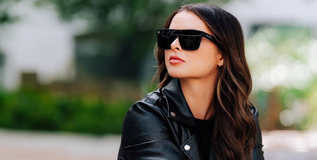 Woman wearing black polarized sunglasses outdoors in a black leather jacket