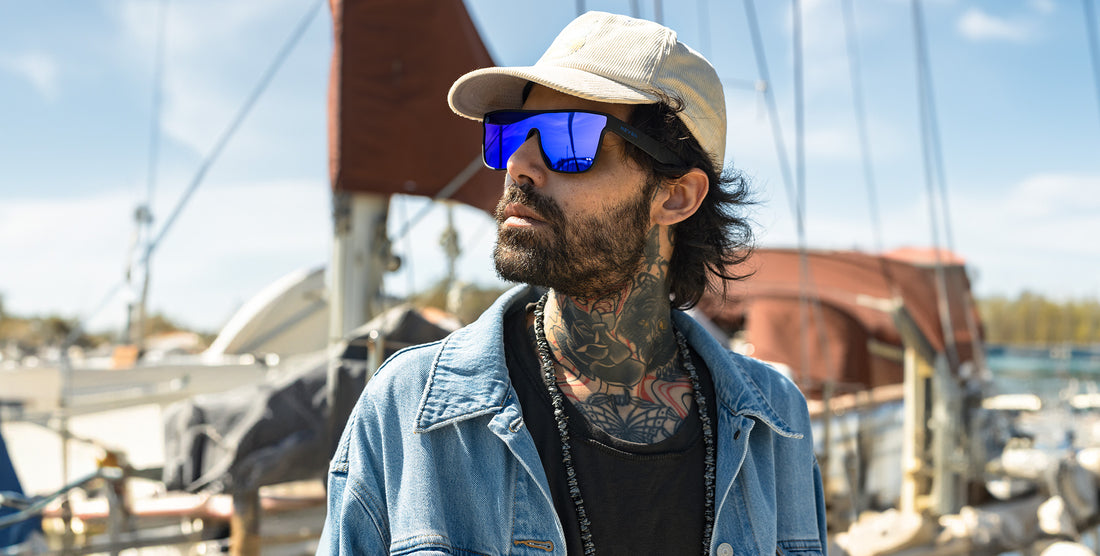 Man wearing Midnight blue polarized sunglasses at a sunny marina