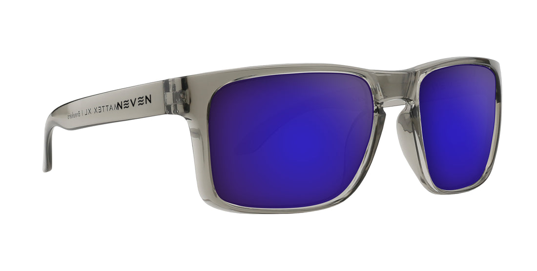 Angled close-up of Breakers Rx sunglasses with transparent gray glossy frame and purple mirrored lenses on white background