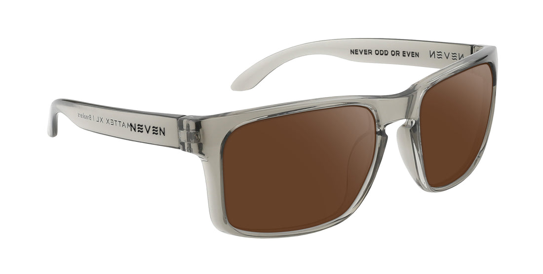 Three-quarter side view of Breakers XL prescription sunglasses with clear translucent rectangular frame, brown lenses, and NEVEN branding on the temple
