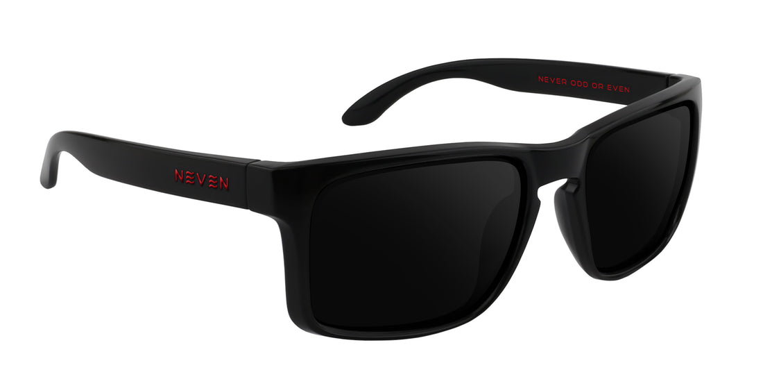 Three-quarter view of John Wayne XL oversized rectangular sunglasses showcasing glossy black TR90 frame and dark prescription lenses on white background