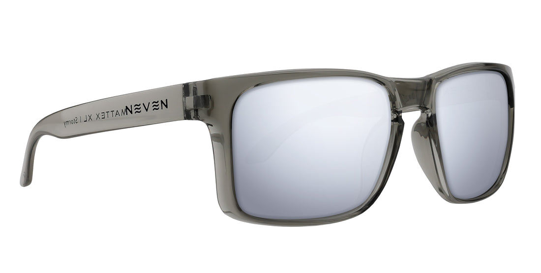 Three-quarter view of Stormy XL sunglasses showing translucent gray oversized frame with mirrored lenses on white background