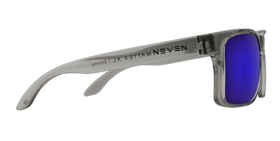 Right side close up of Stormy XL sunglasses showing transparent gray glossy frame, purple mirrored lens, Mattex logo on temple on white