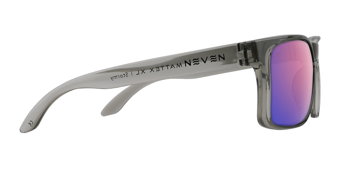 Side view of Stormy XL sunglasses showing translucent gray oversized frame, pink purple mirrored lens, NEVEN logo on white