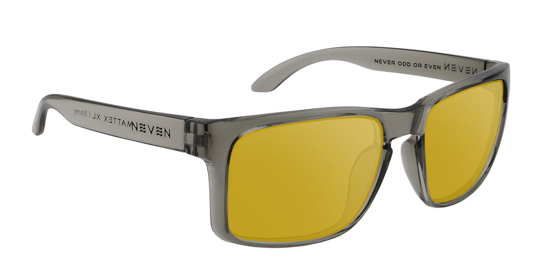 Close up three quarter view of Stormy XL prescription sunglasses with glossy transparent gray frame and yellow lenses