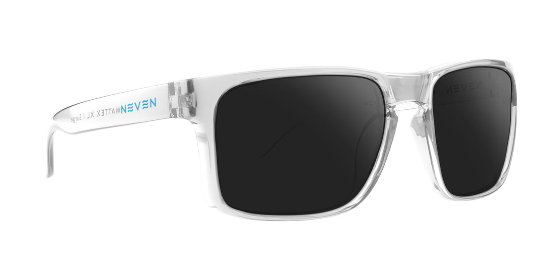 Close-up three-quarter view of Surge XL sunglasses showcasing glossy clear rectangular frames and dark prescription lenses on a white background