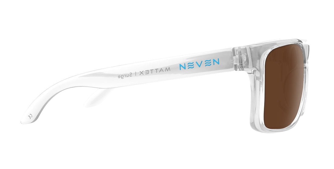 Side close up of Surge prescription sunglasses showing clear frame, brown lens and blue Neven logo on white