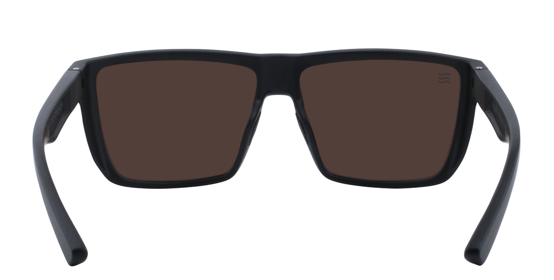 Front close-up of Honest John’s sunglasses showcasing matte black rectangular frame, blue polarized lenses and JM logo on a white background
