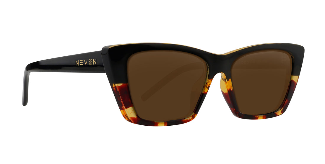 Right-front view of Dusk cat-eye prescription sunglasses showing glossy black-to-tortoise frame, gold logo and brown lenses