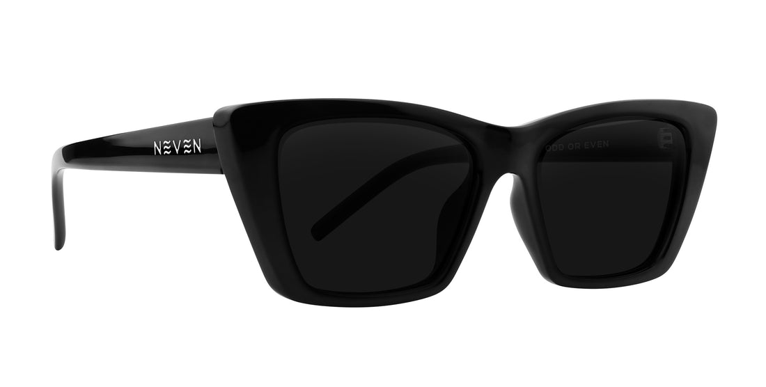 Close-up three-quarter view of Noir cat-eye prescription sunglasses showcasing glossy black frame and silver NEVEN logo on a white background