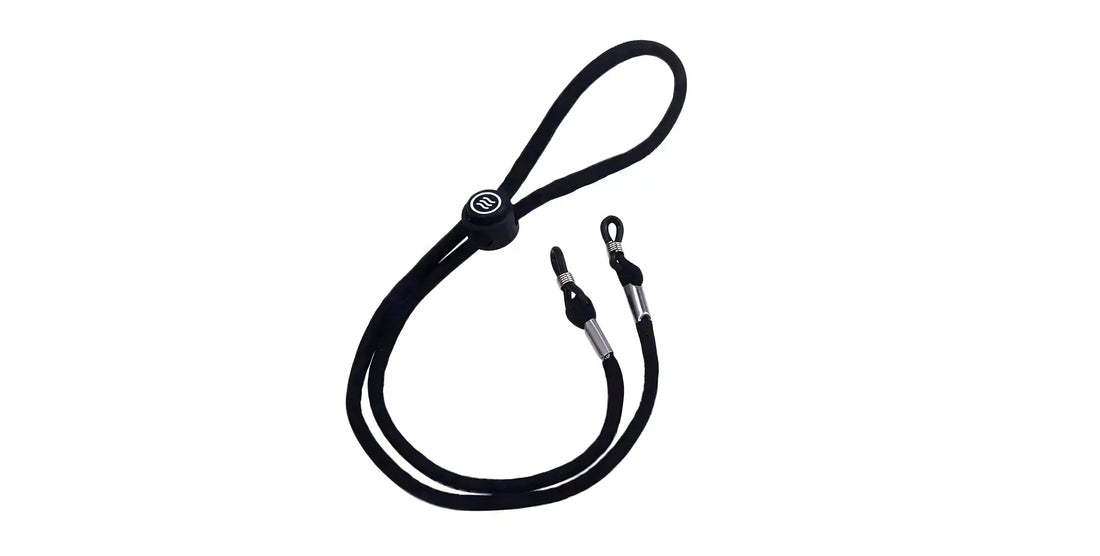 Top view of Signature Strap showing black nylon cord with branded adjustable slider and metal-ended loops on white background