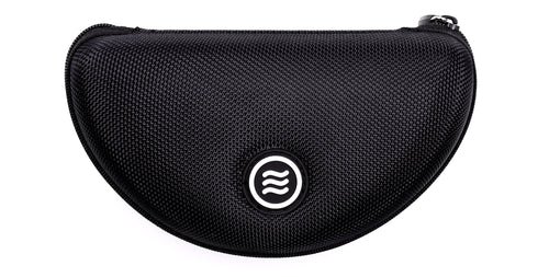 Close-up front of Signature Hard Case showing textured black polyester shell, zippered top, and Tilde logo on white background