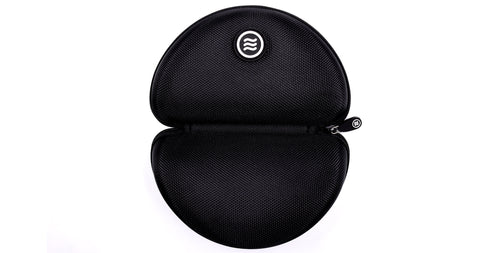 Top-down view of Signature Hard Case open showing zippered closure and Tilde logo on black textured polyester against white background
