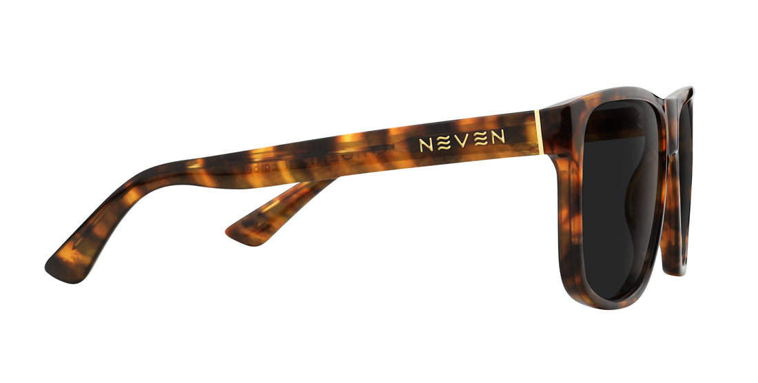 Side view of Ember prescription sunglasses showcasing tortoiseshell frame, dark lenses, and gold Neven logo on white background