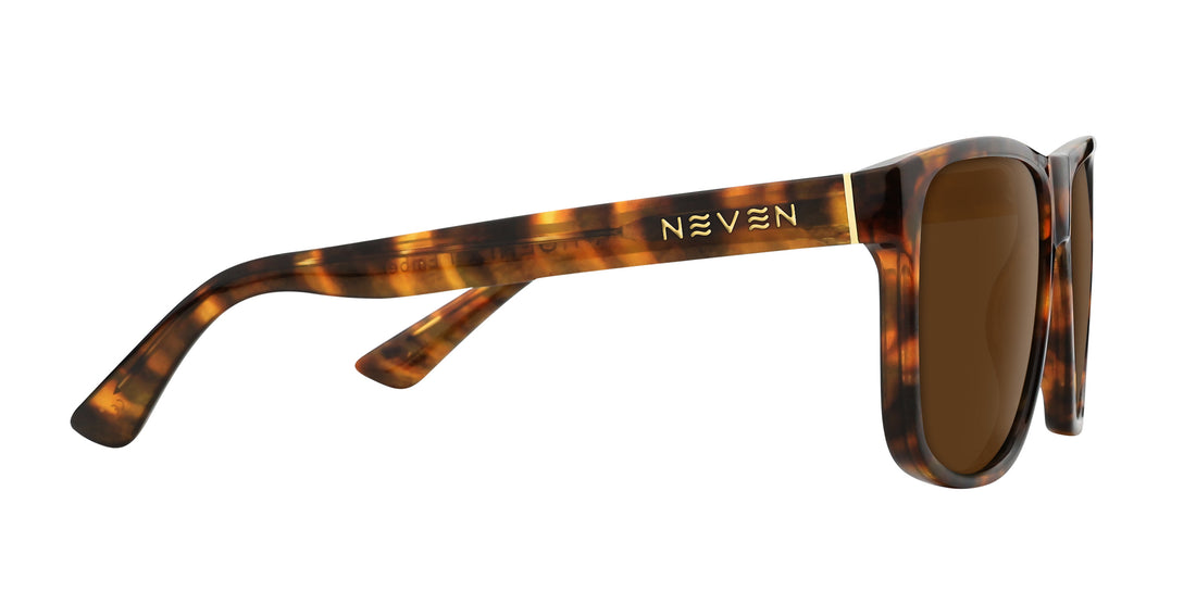 Side close-up of Ember prescription sunglasses showing tortoiseshell frame, gold Neven logo on the temple and brown lenses on white background